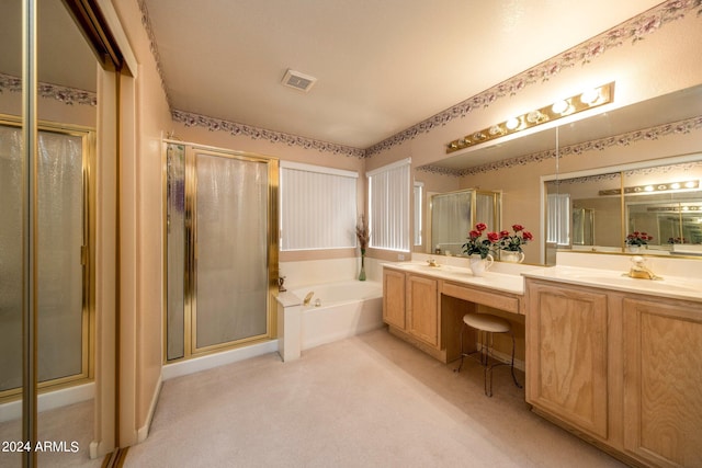 bathroom featuring double sink vanity and shower with separate bathtub