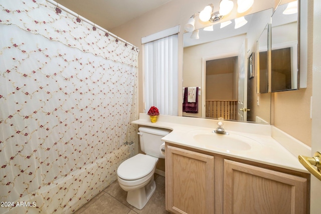 bathroom featuring vanity, tile floors, and toilet