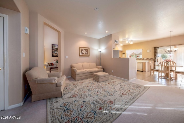 carpeted living room featuring an inviting chandelier