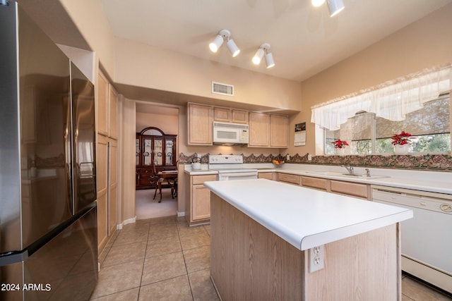 kitchen with light tile flooring, white appliances, light brown cabinets, sink, and a kitchen island