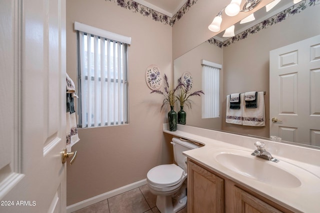 bathroom featuring toilet, tile floors, and vanity