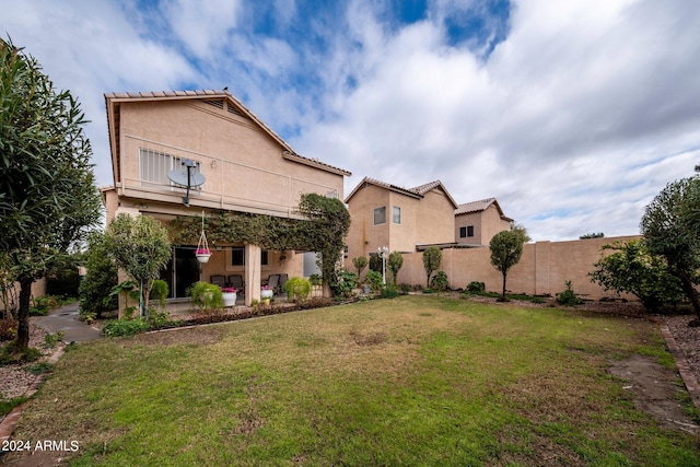 rear view of property with a lawn