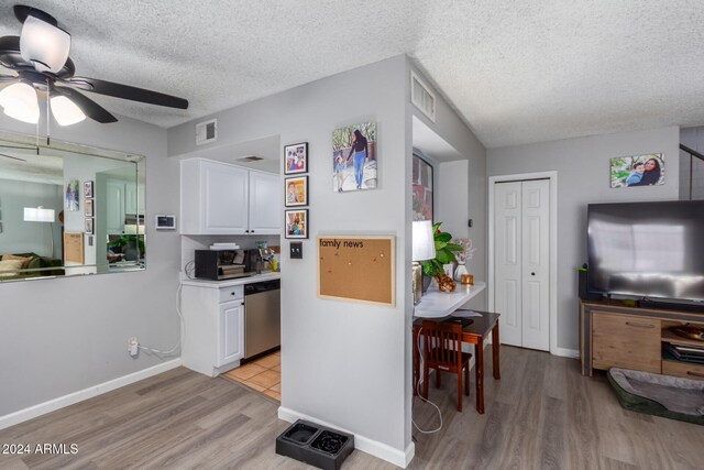 kitchen featuring white cabinets, light wood-type flooring, and dishwasher