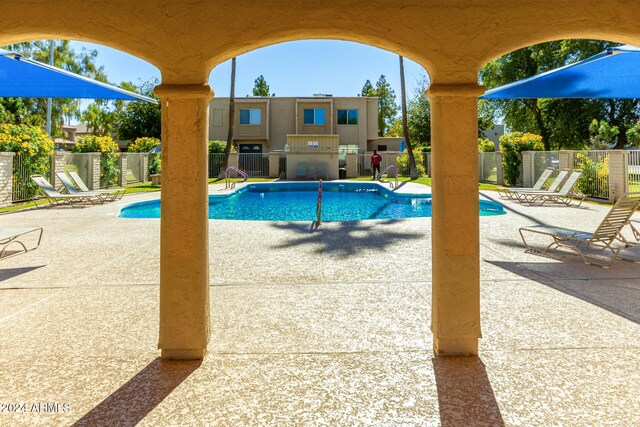 view of swimming pool featuring a patio area