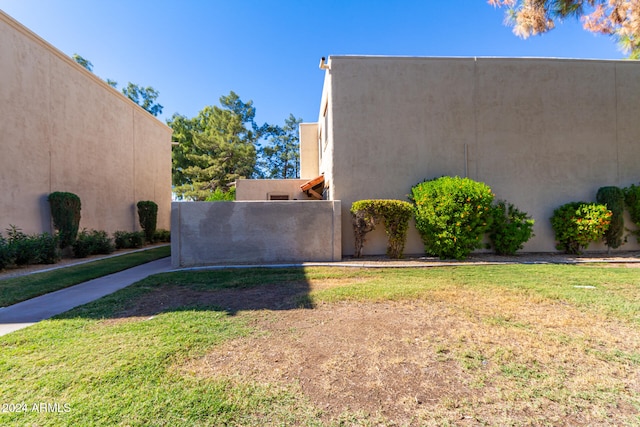 view of side of home with a lawn