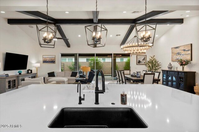 17146 W Mountainair St, Surprise, AZ 85388 - kitchen featuring a chandelier, a sink, open floor plan, pendant lighting, and recessed lighting