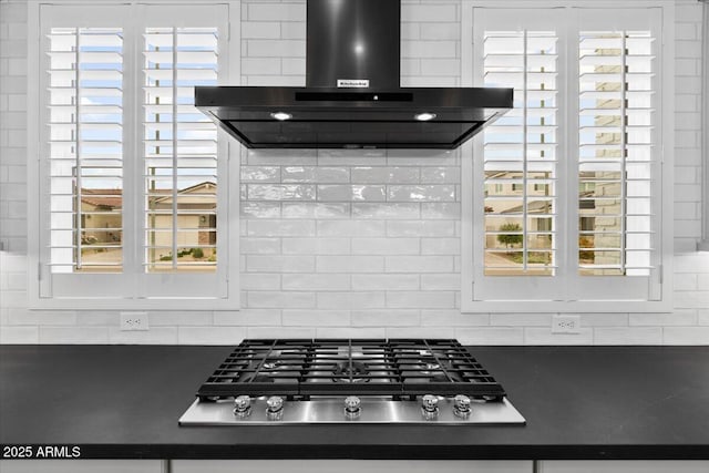 17146 W Mountainair St, Surprise, AZ 85388 - detailed view of ventilation hood, dark countertops, stainless steel gas cooktop, and backsplash