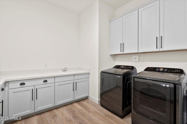 17146 W Mountainair St, Surprise, AZ 85388 - laundry area with separate washer and dryer, cabinet space, light wood-style flooring, and baseboards