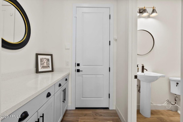 17146 W Mountainair St, Surprise, AZ 85388 - doorway to outside with wood finished floors, baseboards, and a sink