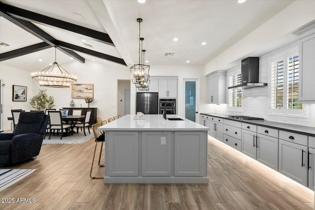 17146 W Mountainair St, Surprise, AZ 85388 - kitchen featuring stainless steel appliances, a sink, wall chimney range hood, a chandelier, and recessed lighting