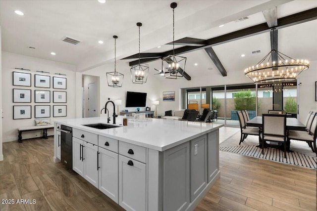 17146 W Mountainair St, Surprise, AZ 85388 - kitchen with a chandelier, a sink, open floor plan, wood finished floors, and recessed lighting