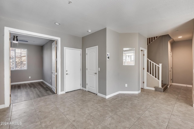 tiled entrance foyer with ceiling fan