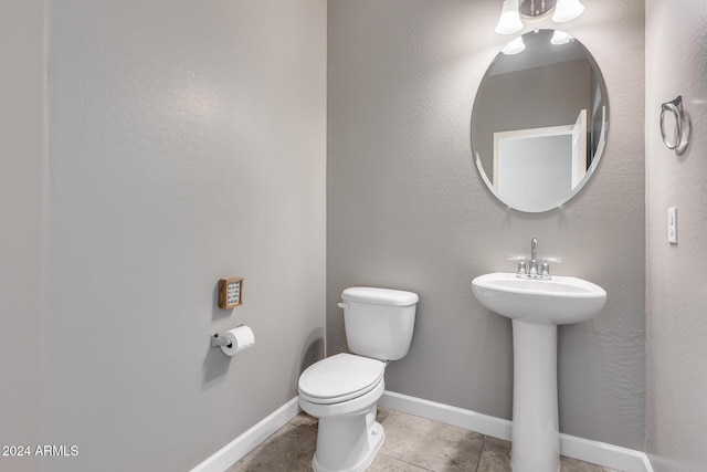 bathroom featuring tile patterned floors, toilet, and sink