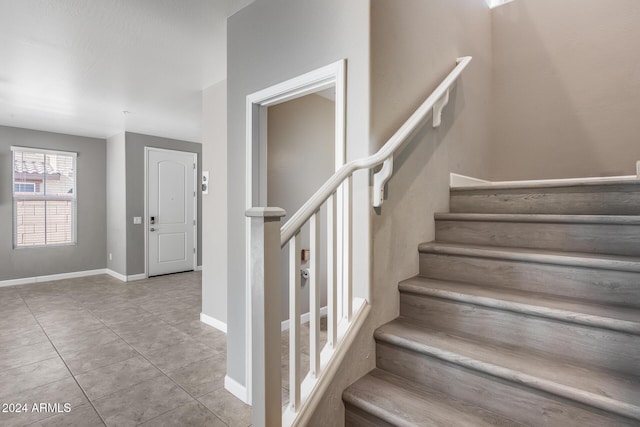 staircase with tile patterned flooring