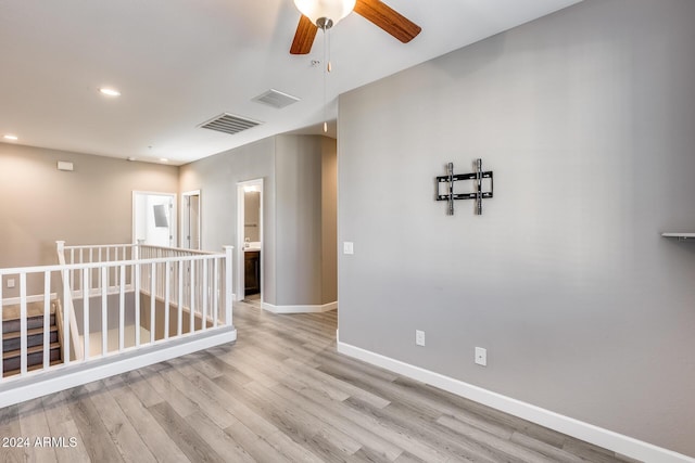 empty room featuring ceiling fan and light hardwood / wood-style flooring