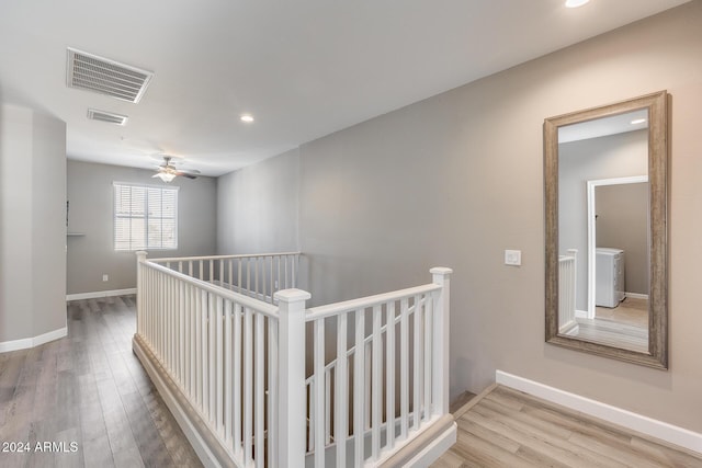 hallway with washer / clothes dryer and wood-type flooring