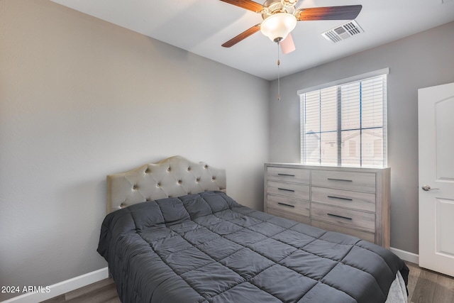 bedroom featuring dark hardwood / wood-style flooring and ceiling fan