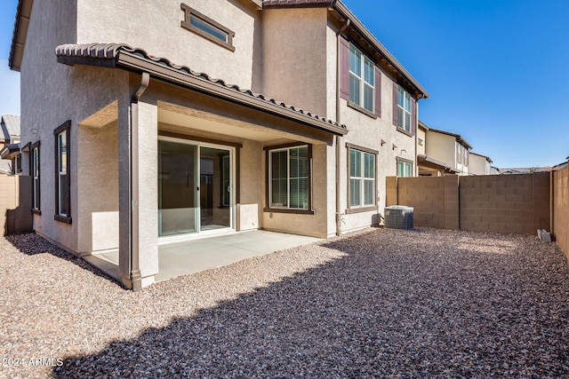 rear view of property featuring central air condition unit and a patio area