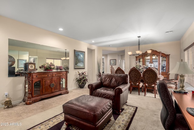 living room with plenty of natural light, visible vents, a notable chandelier, and recessed lighting