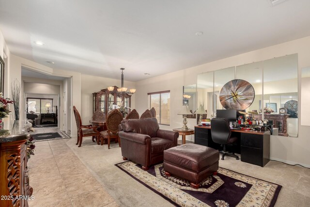 living area with recessed lighting and an inviting chandelier