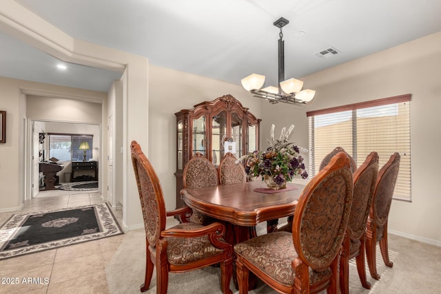 dining room with light tile patterned floors, baseboards, visible vents, and an inviting chandelier