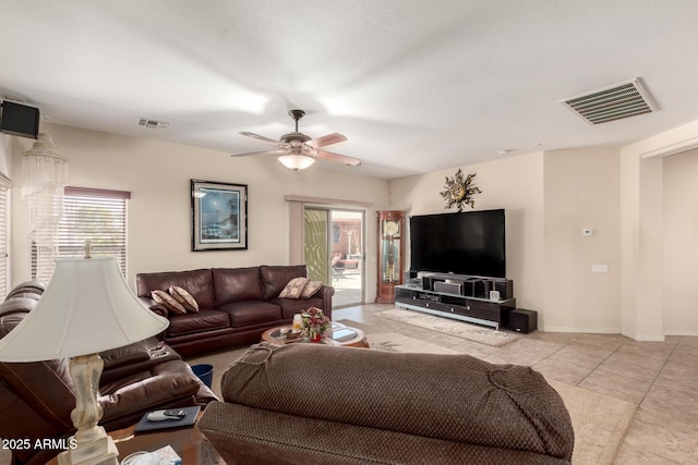 living room featuring light tile patterned floors, baseboards, visible vents, and a ceiling fan