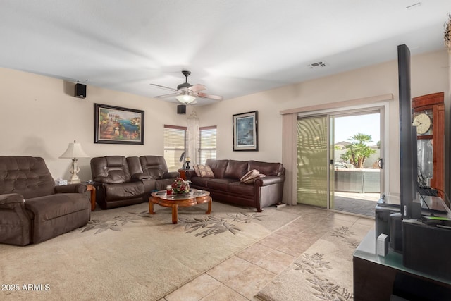 living area featuring light tile patterned floors, ceiling fan, and visible vents