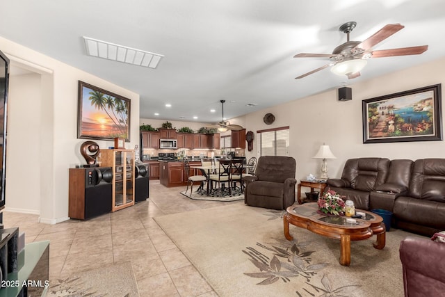 living area featuring a ceiling fan, recessed lighting, visible vents, and light tile patterned flooring