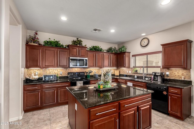 kitchen featuring tasteful backsplash, dark stone counters, a kitchen island, black appliances, and a sink