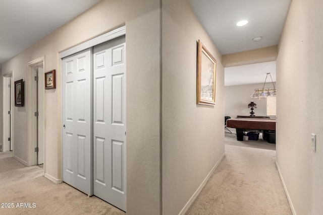 hall featuring light carpet, recessed lighting, and baseboards