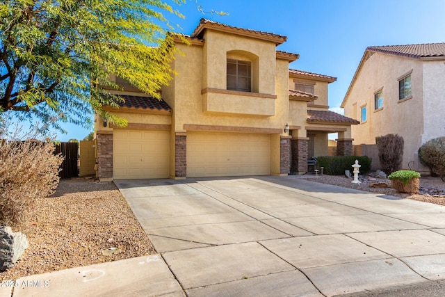 view of front of home with a garage, a tile roof, fence, concrete driveway, and stucco siding