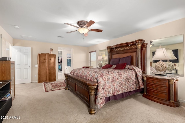 bedroom with visible vents, a ceiling fan, and light colored carpet