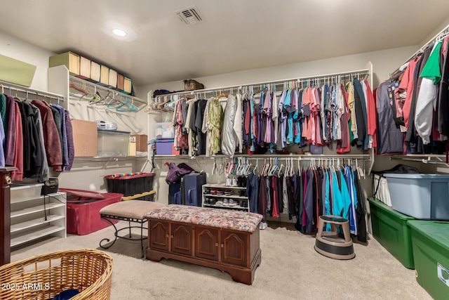 spacious closet featuring visible vents and light colored carpet