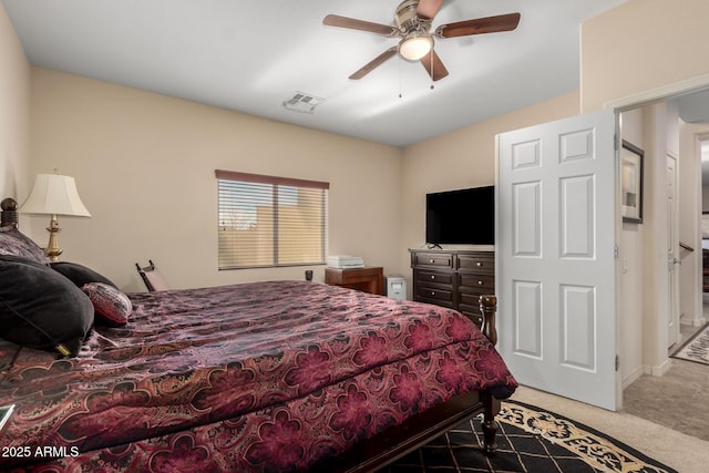 carpeted bedroom with a ceiling fan and visible vents