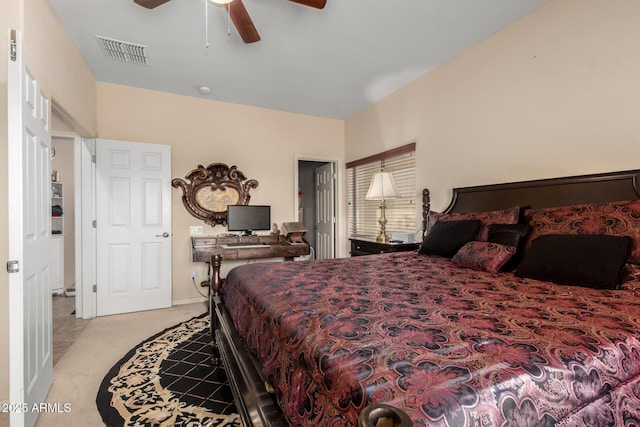 bedroom with visible vents, a ceiling fan, and light colored carpet