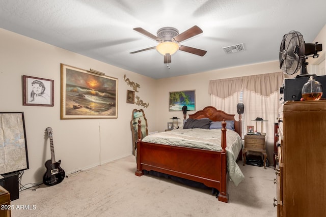 bedroom with light carpet, visible vents, and a ceiling fan