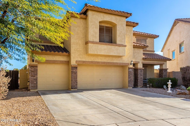 mediterranean / spanish house featuring stucco siding, concrete driveway, an attached garage, stone siding, and a tiled roof