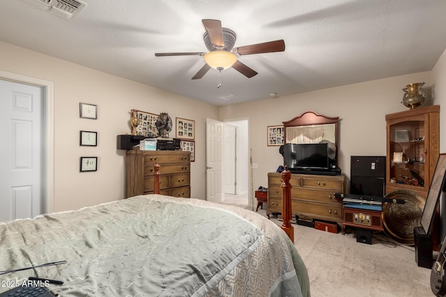 carpeted bedroom featuring visible vents and a ceiling fan