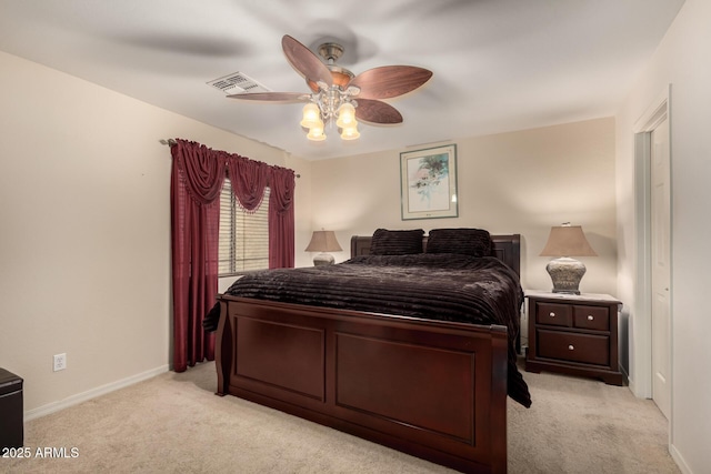 bedroom featuring light carpet, baseboards, visible vents, and a ceiling fan