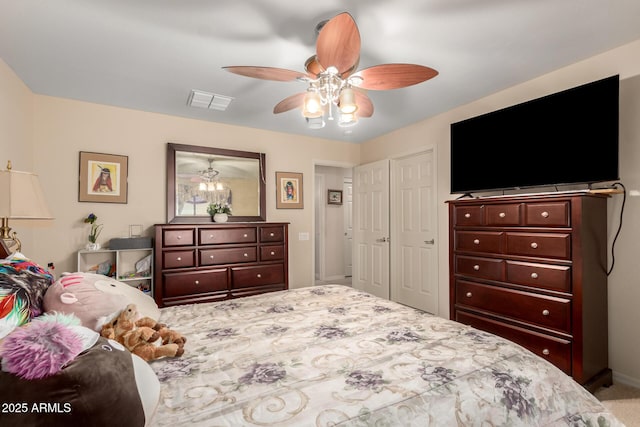 bedroom featuring light carpet, ceiling fan, and visible vents