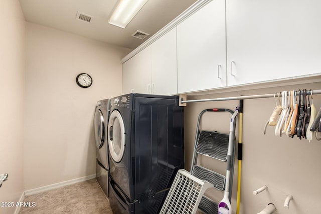 laundry room with washer and dryer, cabinet space, visible vents, and baseboards