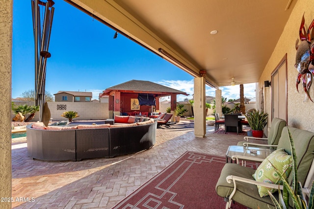 view of patio / terrace featuring an outdoor hangout area, outdoor dining area, an outdoor structure, and a fenced backyard