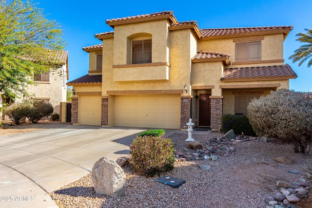 mediterranean / spanish home featuring a tile roof, stucco siding, concrete driveway, an attached garage, and stone siding