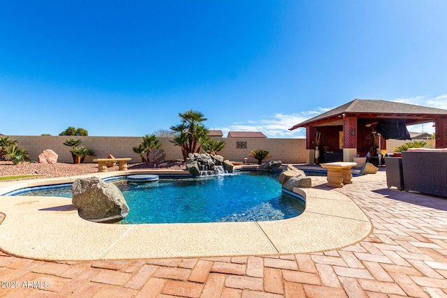 view of pool with a fenced in pool, a patio area, a fenced backyard, and a gazebo