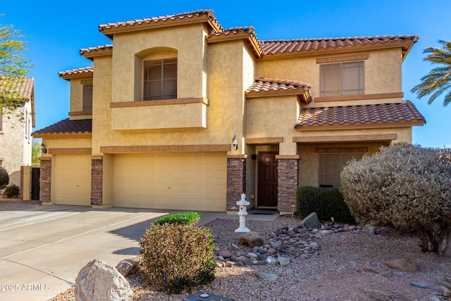 mediterranean / spanish home with a garage, stone siding, driveway, and stucco siding