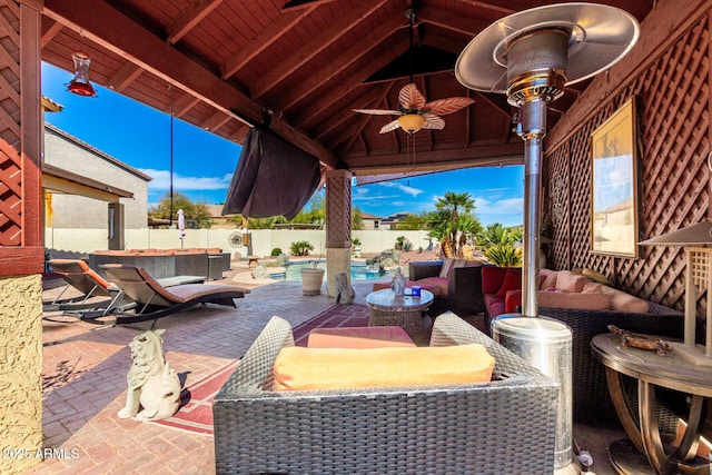 view of patio / terrace featuring a fenced in pool, a gazebo, an outdoor hangout area, ceiling fan, and a fenced backyard