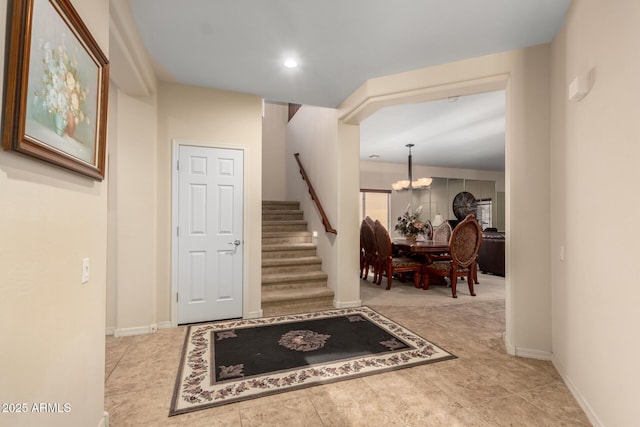 entrance foyer with baseboards, stairway, recessed lighting, and a notable chandelier