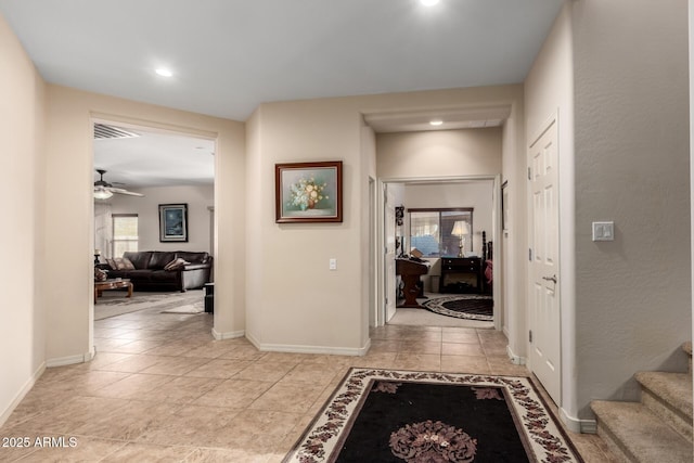 corridor featuring light tile patterned floors, visible vents, baseboards, and recessed lighting