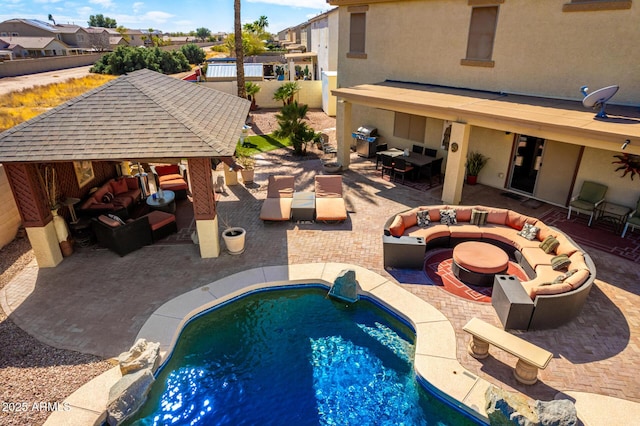 pool with a patio, a fire pit, fence, a grill, and a gazebo