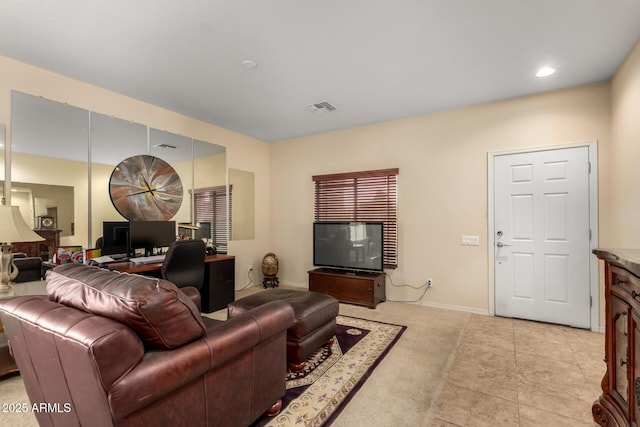 living area featuring baseboards and visible vents